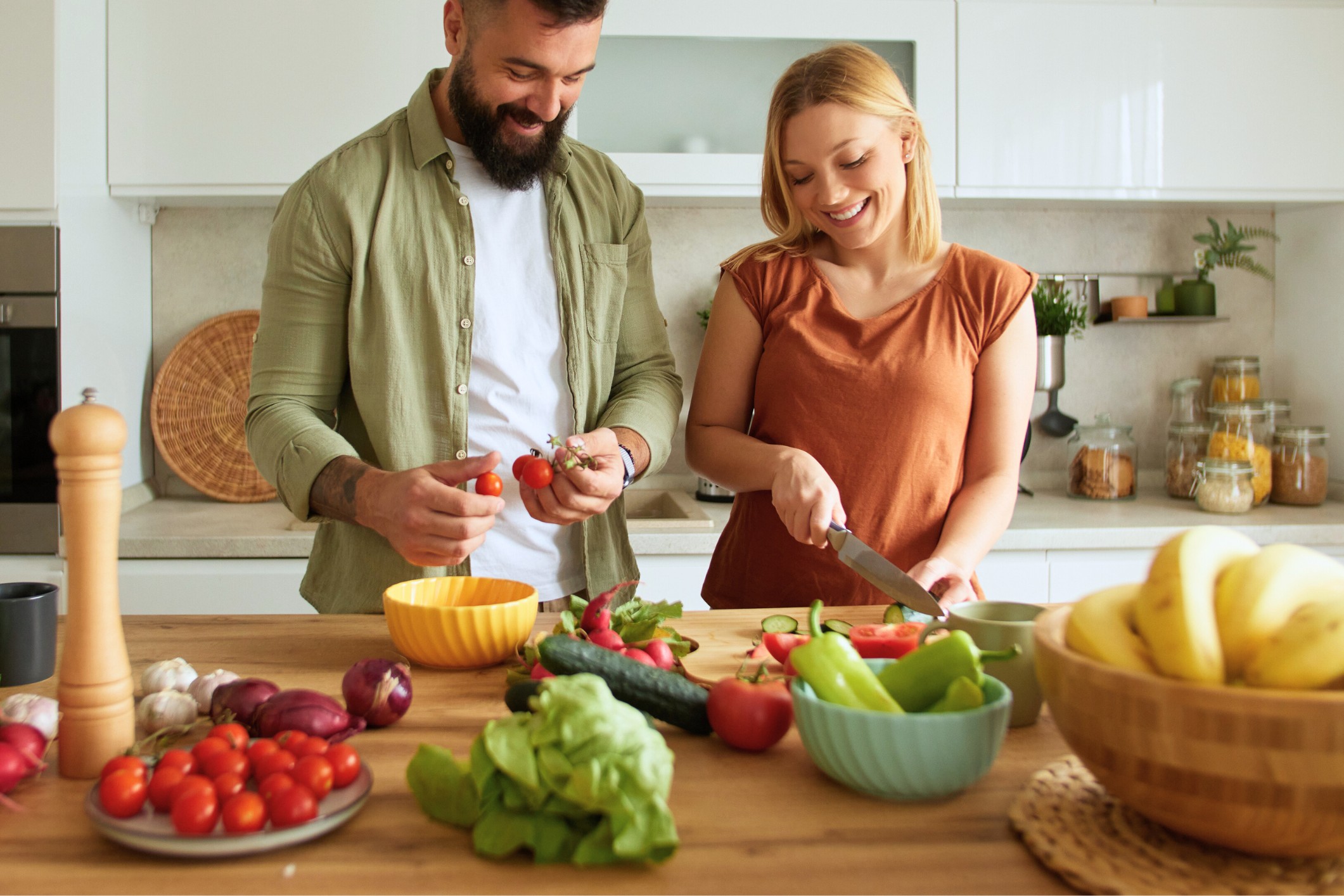 healthy couple preparing meals in the kitchen